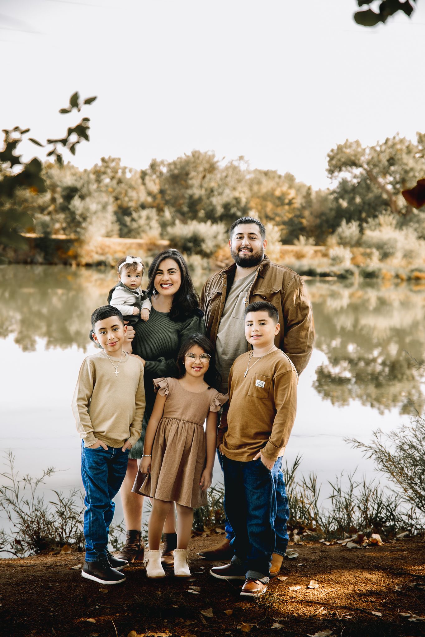 A family of 6 smiling for family pictures in Evans Colorado. Liz Rivas with Illuminating Images photography