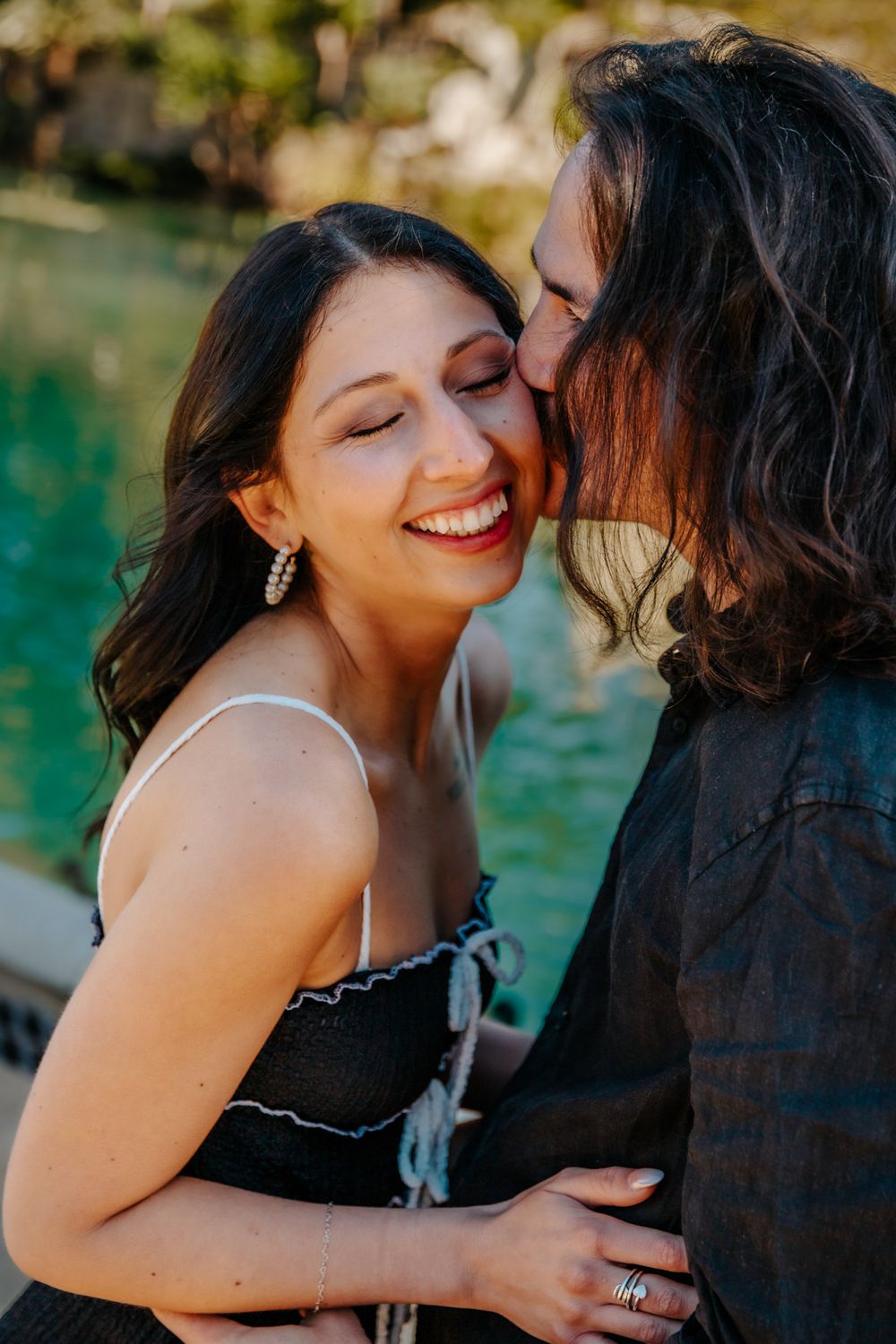 Sarah & Spencer laughing together in a joyful candid photo.