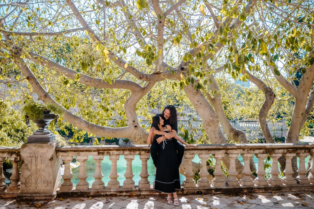 Couple walking hand in hand through Ciutadella Park’s charming paths.