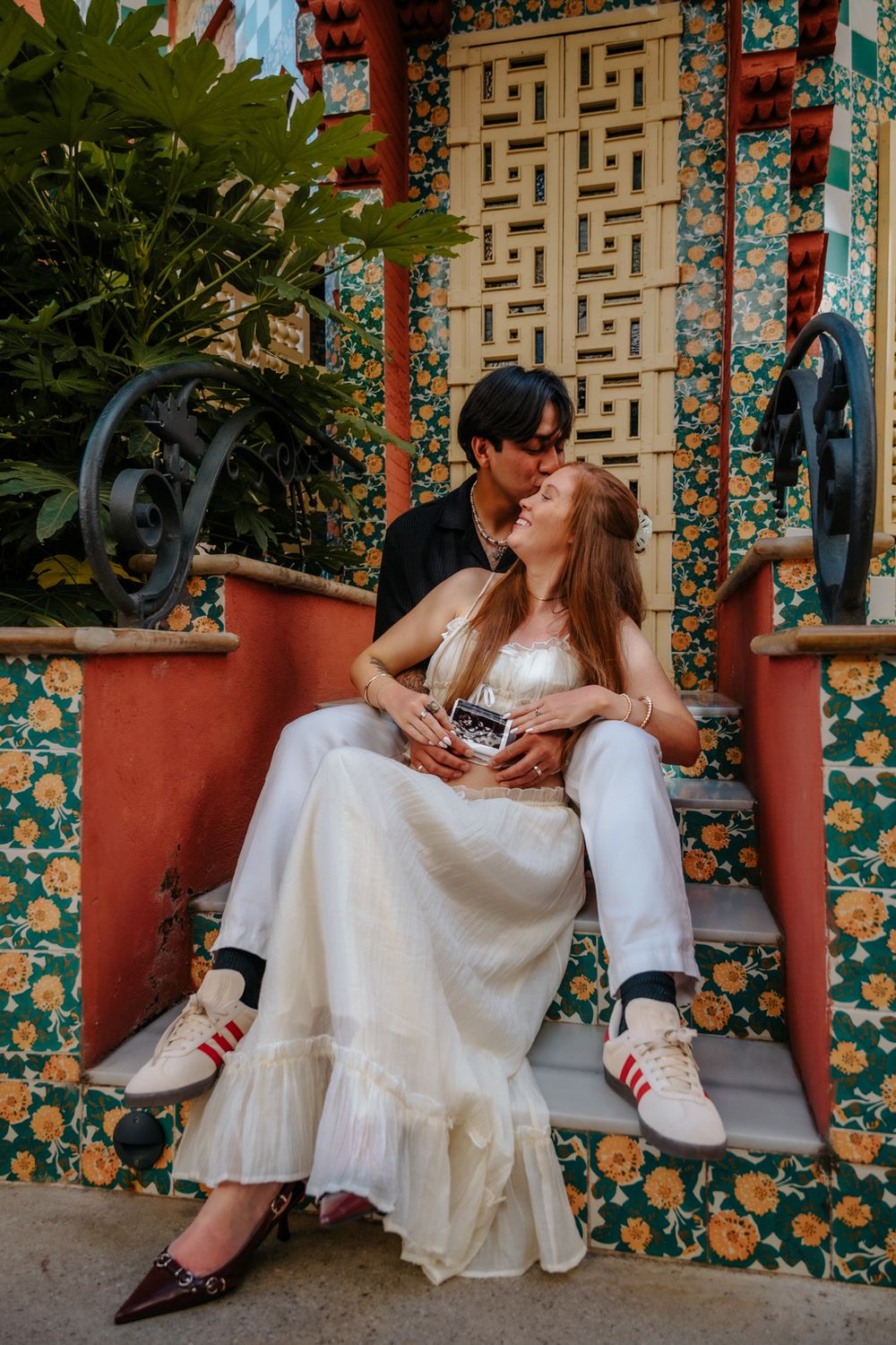Colorful maternity photoshoot moment of Jenna & Juan surrounded by Gaudí’s designs.