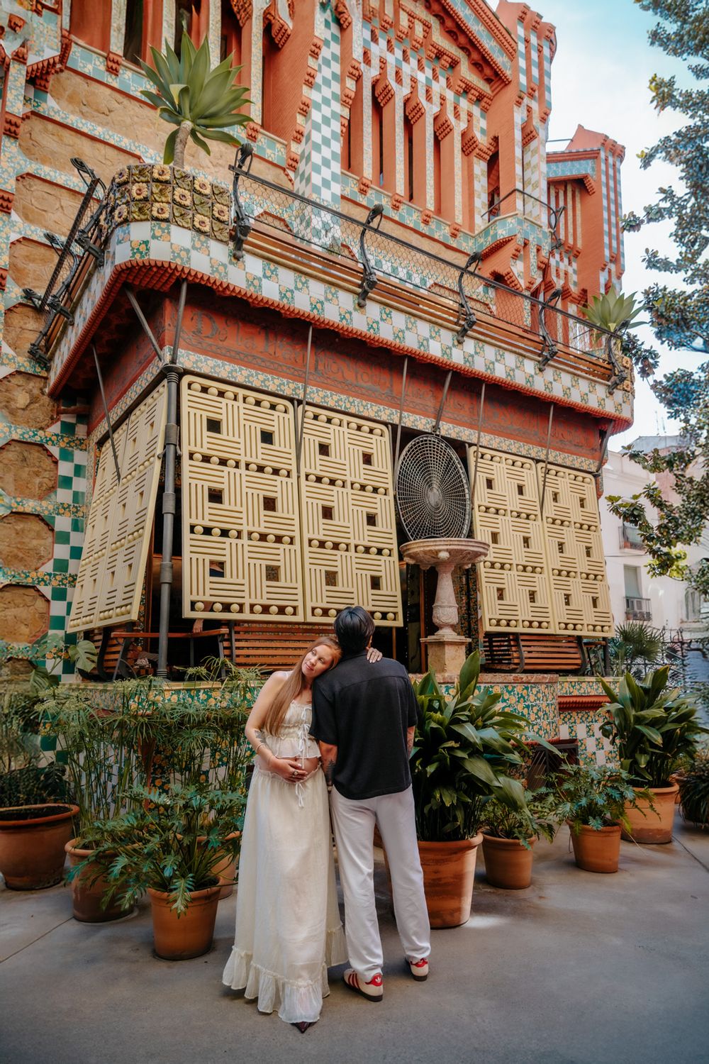 Couple walking hand in hand through Casa Vicens celebrating their baby boy.