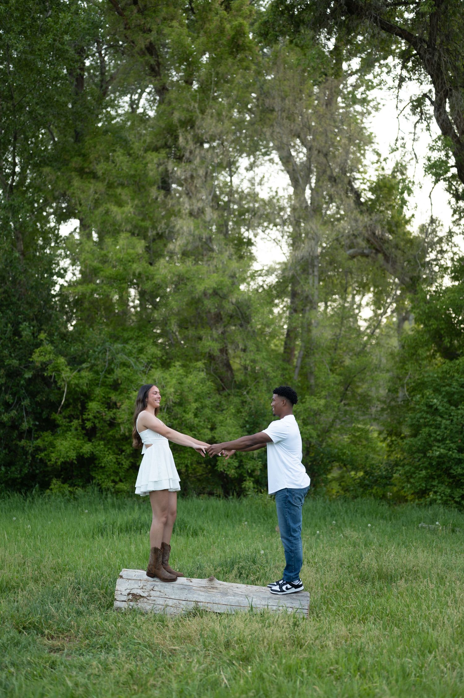 A special moment captured in a lush green field during a proposal.