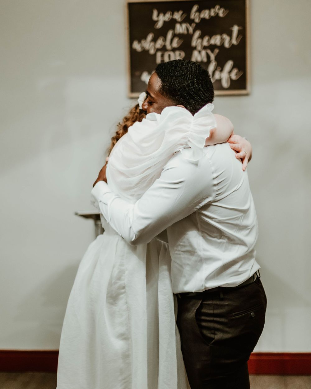 Series of tender embrace photos showing couple having special moment against backdrop with inspirational text.