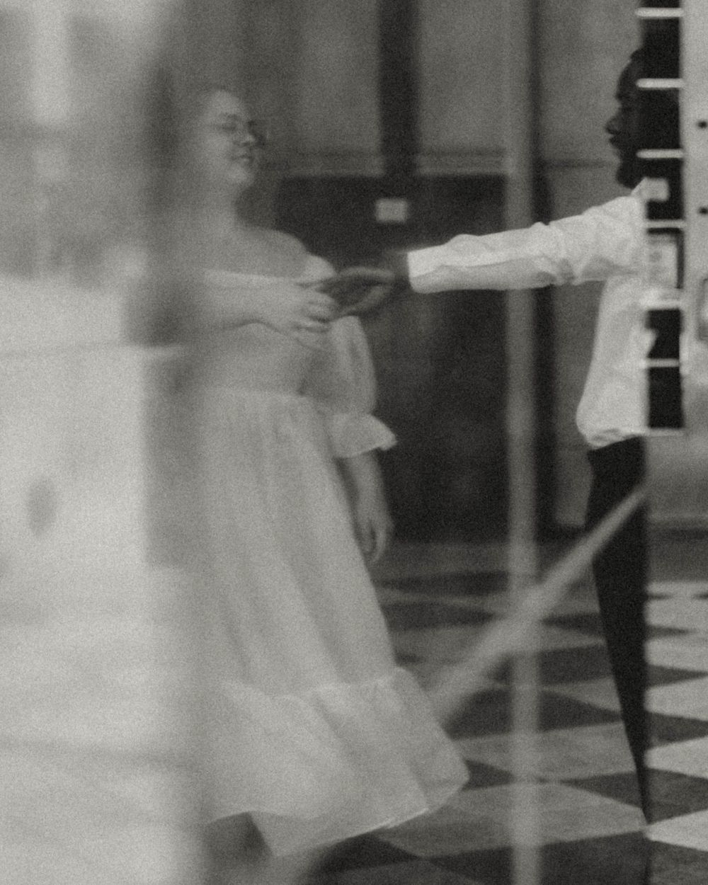Multiple blurry grainy black and white photographs showing a figure in motion against a light background.