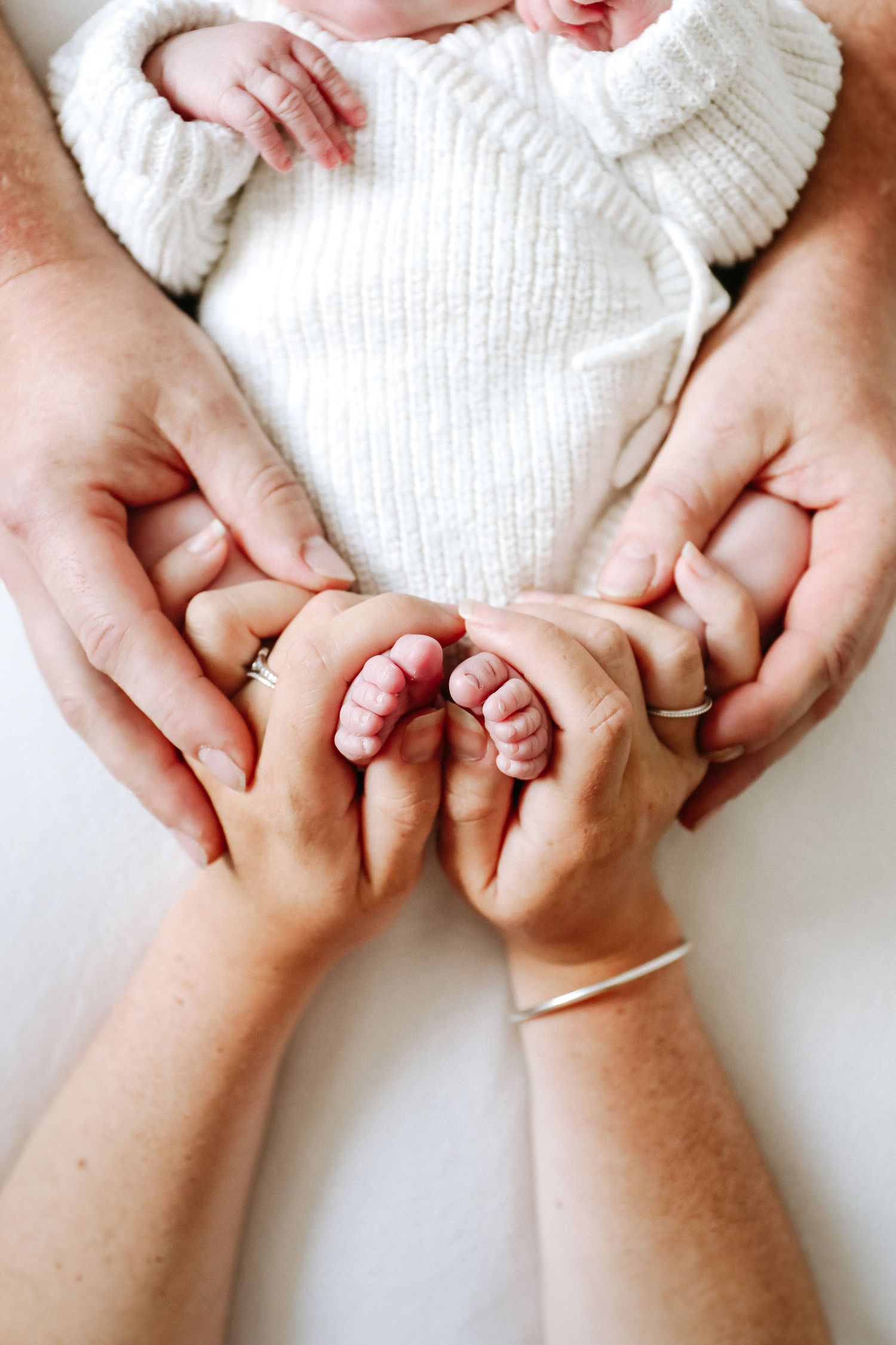 Newborn photography Nottingham baby close up of tiny newborn foot together with mum and dads hands detail shot