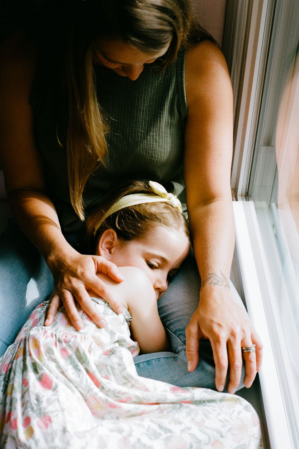 Intimate series of photographs showing gentle nurturing moments by window light.
