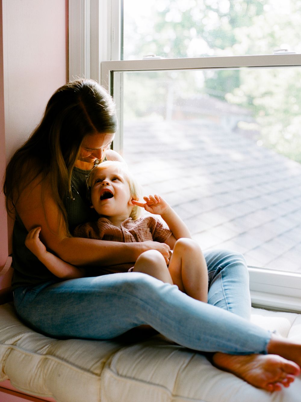Series of relaxed moments by a bright window with people lounging together.