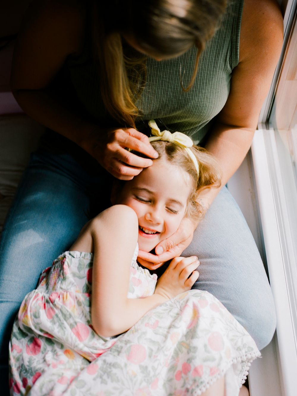 Dreamy natural light photography captures peaceful resting moments by window.