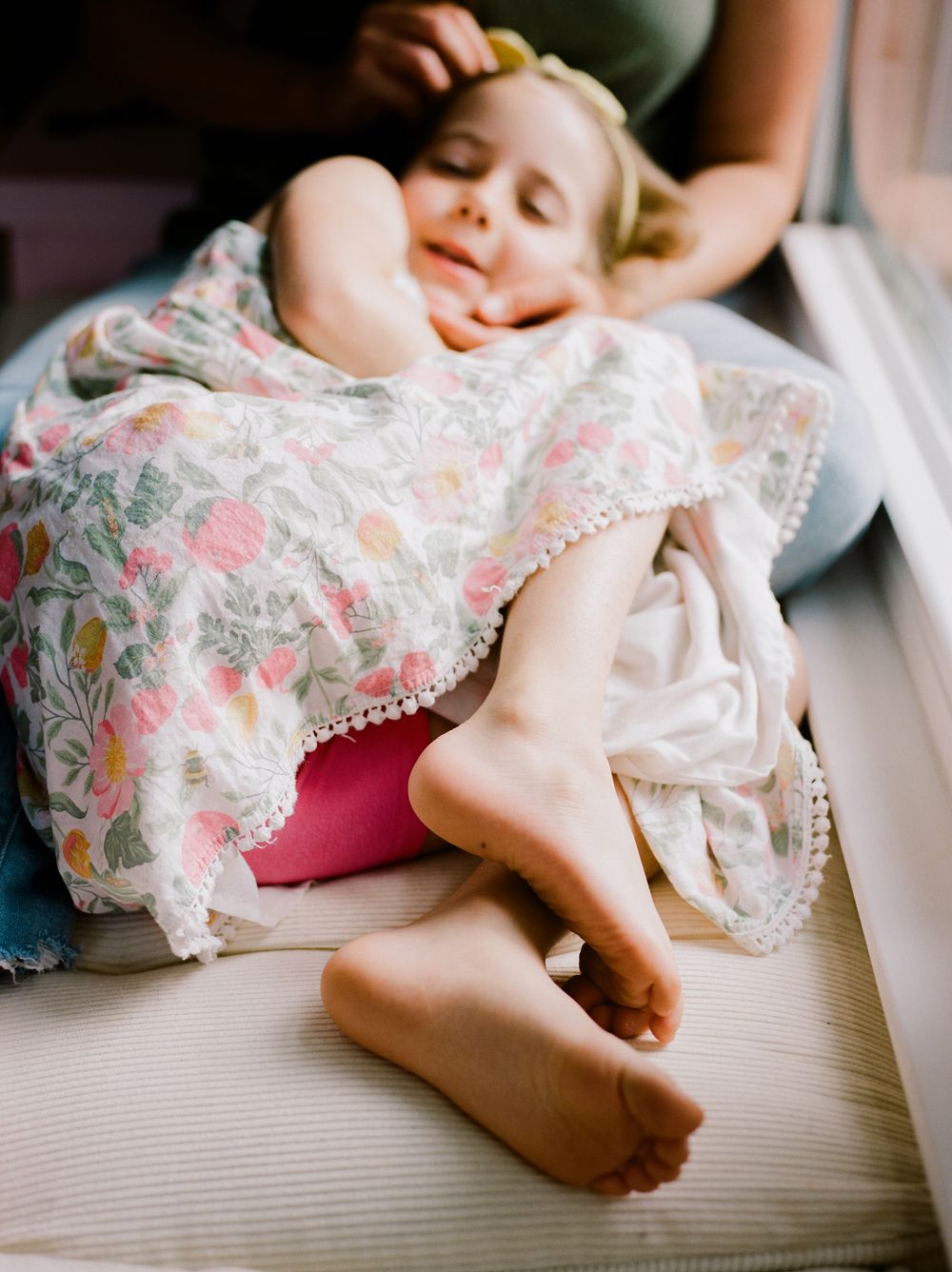 A close-up series of images showing tiny baby feet in delicate lace dress details.