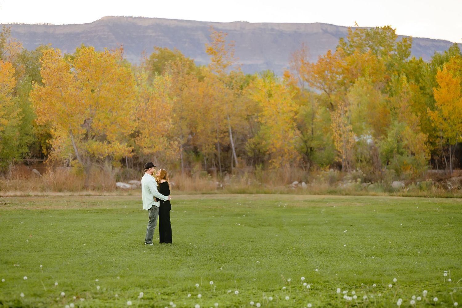 family sharing joyful laughter while gathered closely together outdoors.