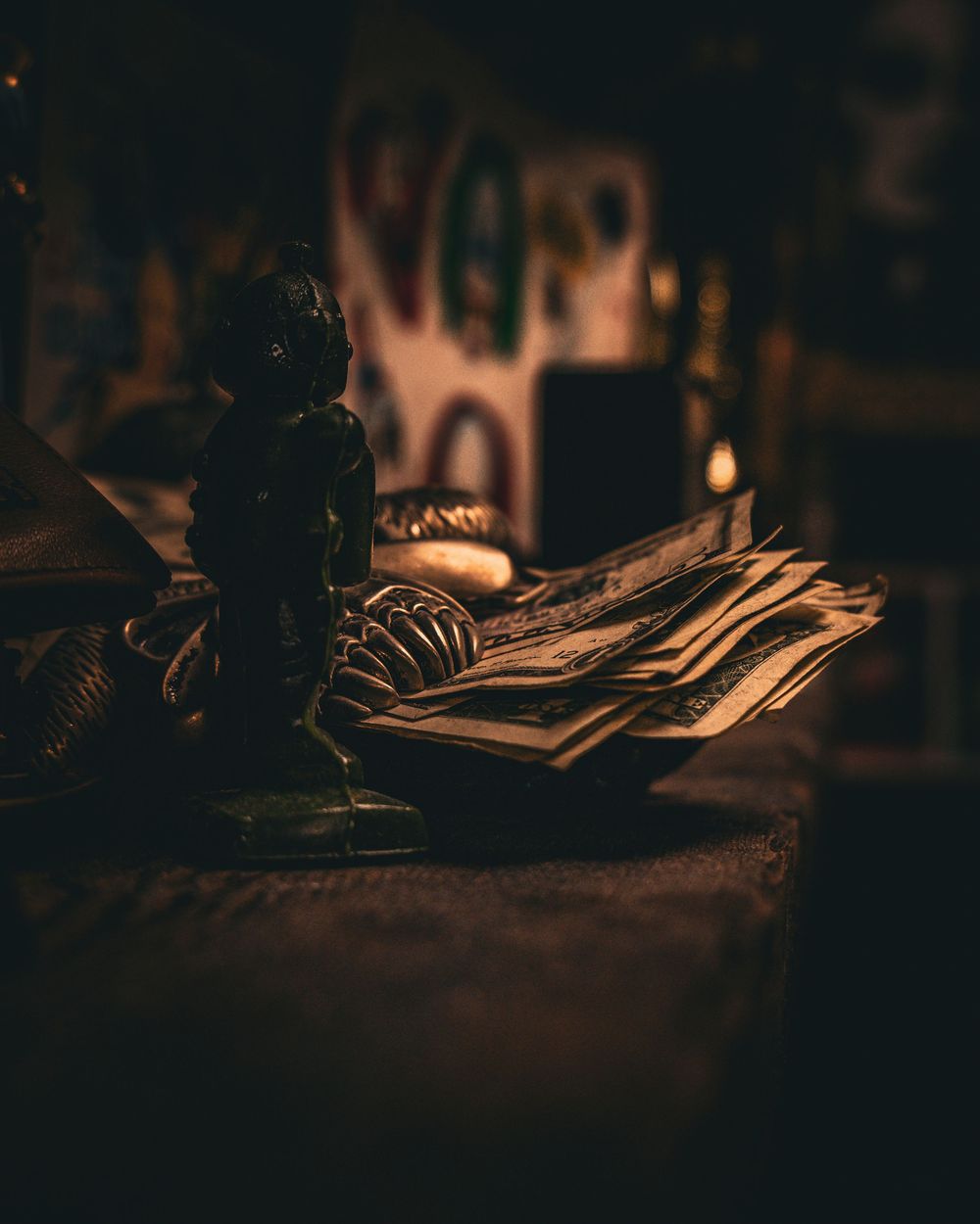 Dark moody photograph of vintage books and documents on wooden surface.