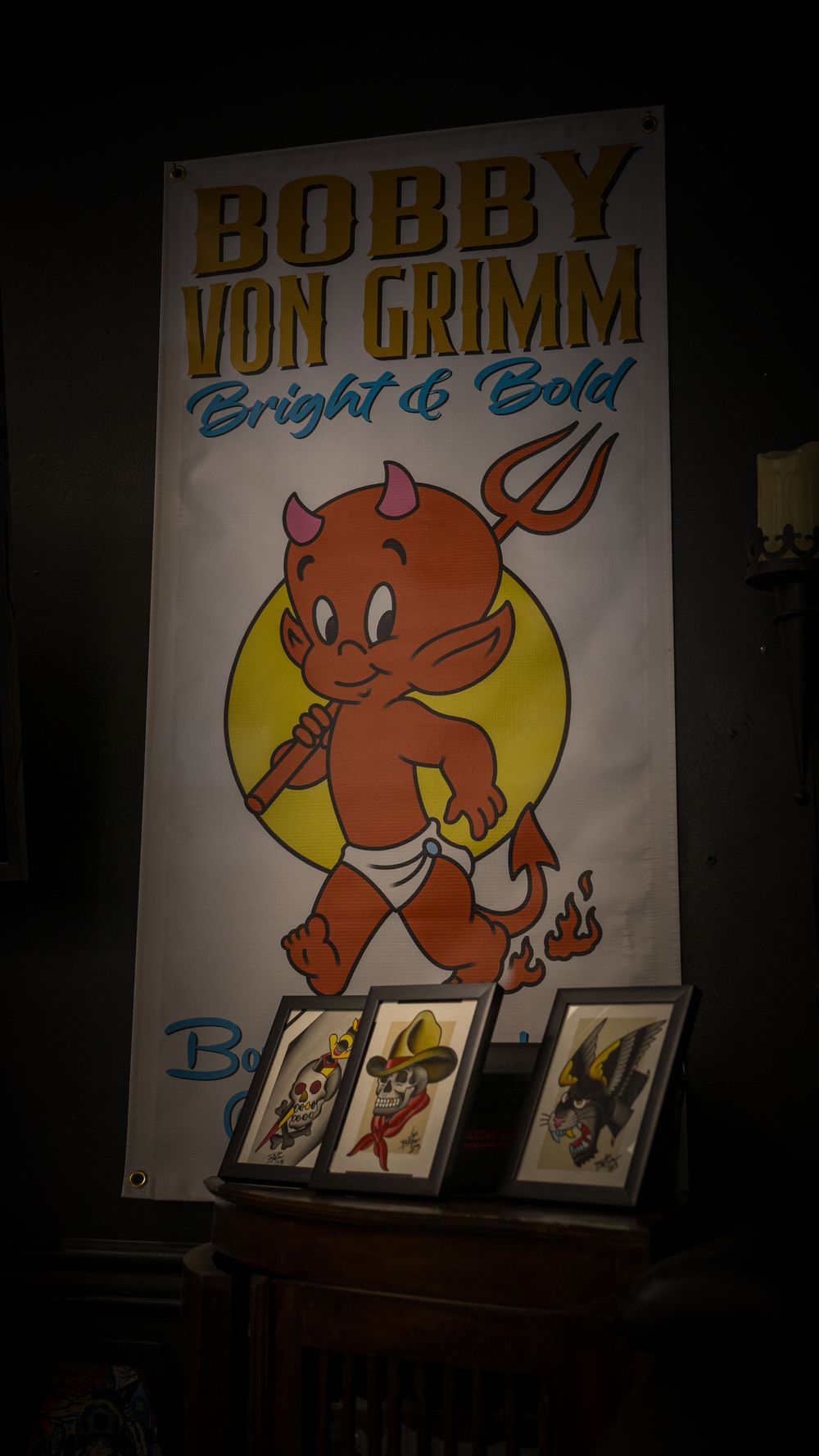 Cartoon devil character artwork displayed on illuminated signage.