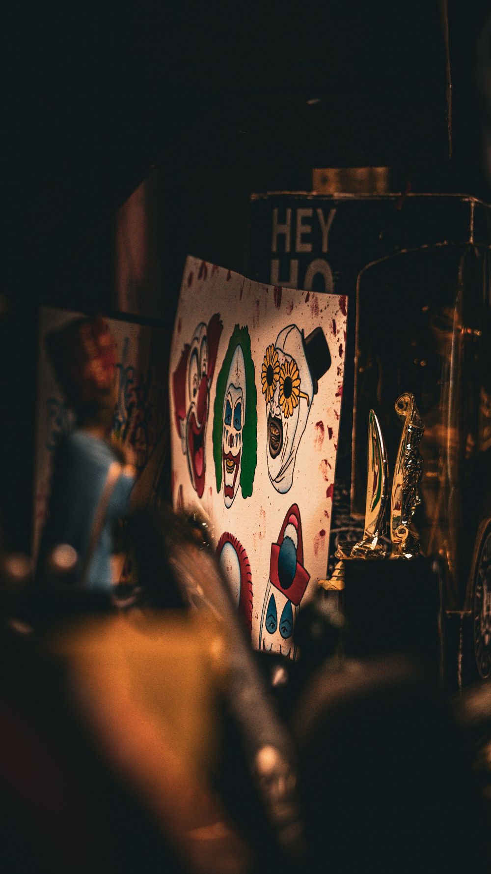 Art display showing colorful designs on wall in dim lighting.