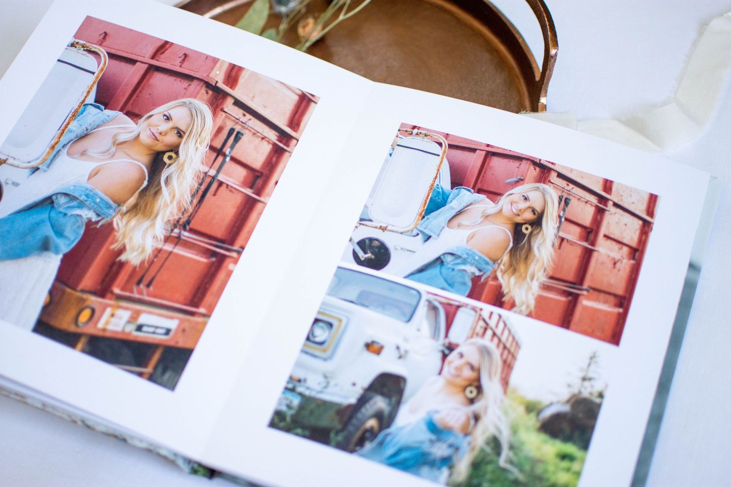 Photo album spreads featuring outdoor portrait sessions with rustic red backgrounds.