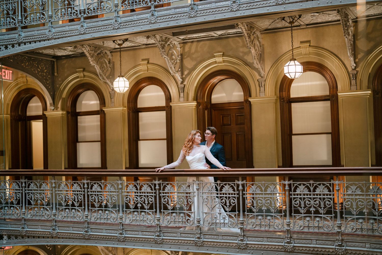 An ornate historic building interior with decorative railings and arched columns.