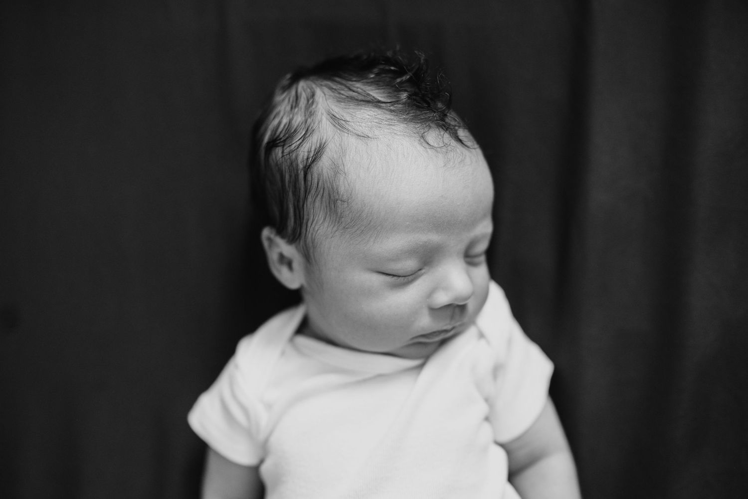 Peaceful black and white portrait of sleeping newborn.