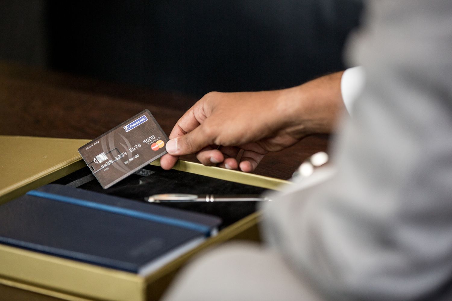 Close-up shots of hands working with digital tablet devices on desk surface.