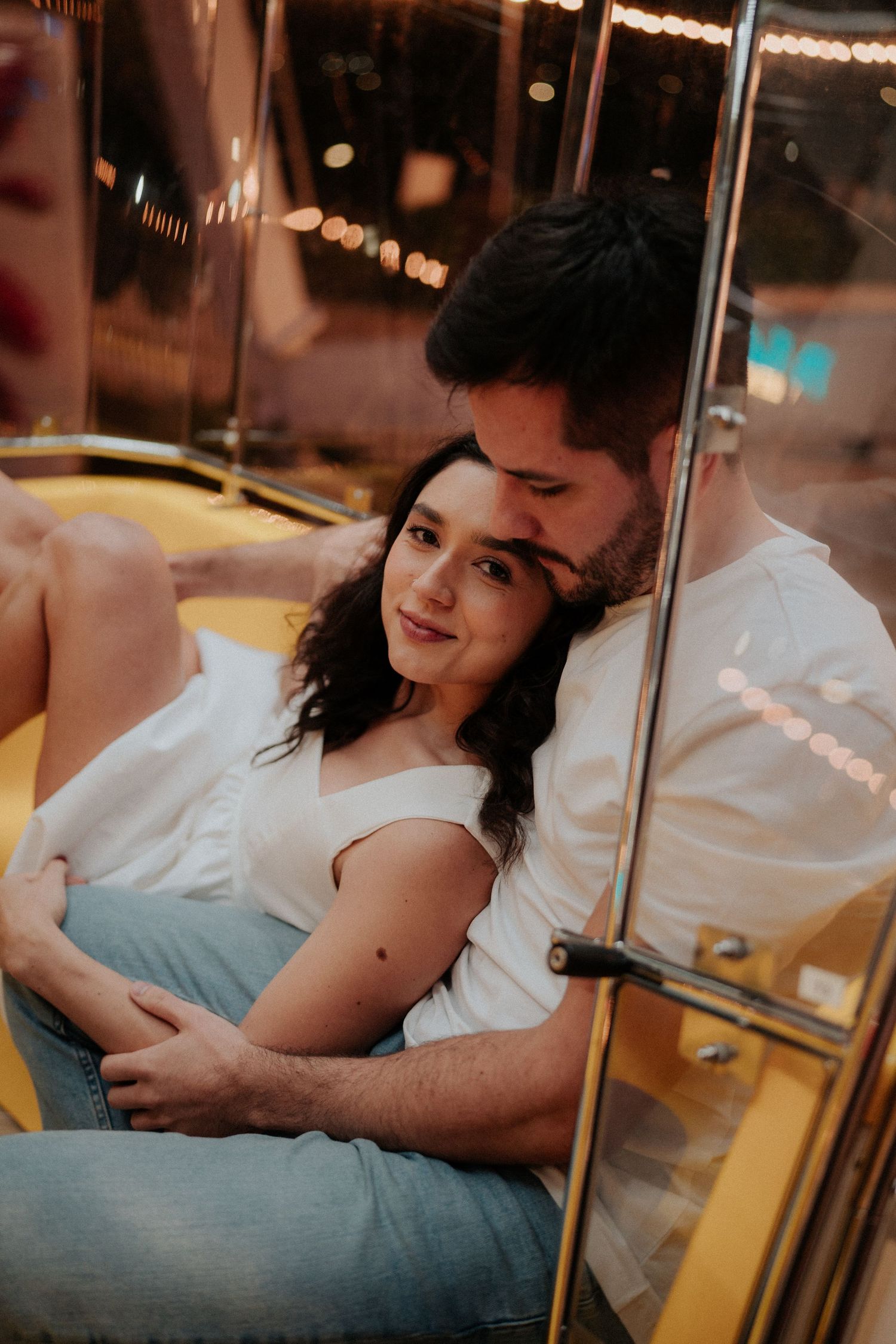 Couple relaxing together in a retro-styled amusement park ride compartment.