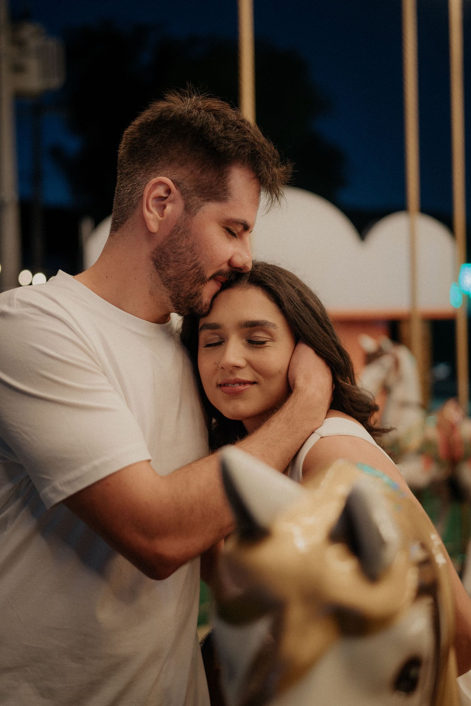 Intimate close-up shots of a couple sharing tender moments under ambient lighting.