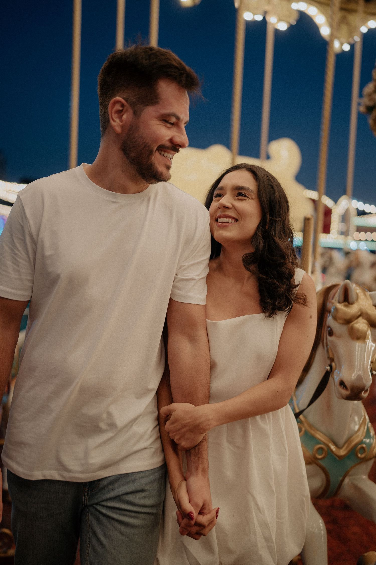 Couple sharing joyful moments while dancing together at an evening event.
