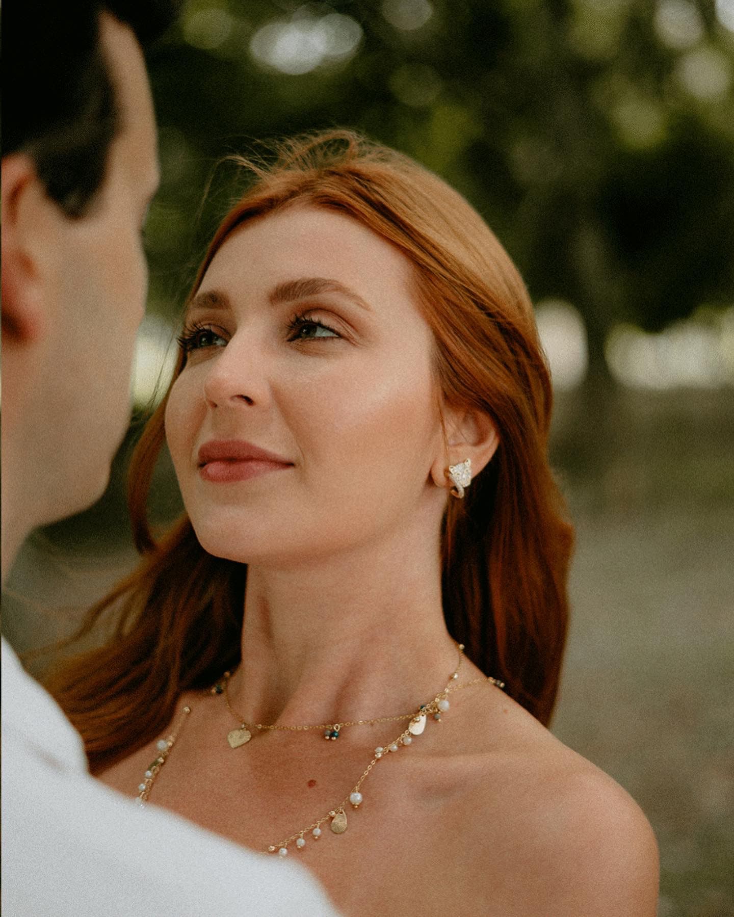 A close-up portrait capturing a romantic moment between a couple in natural lighting.