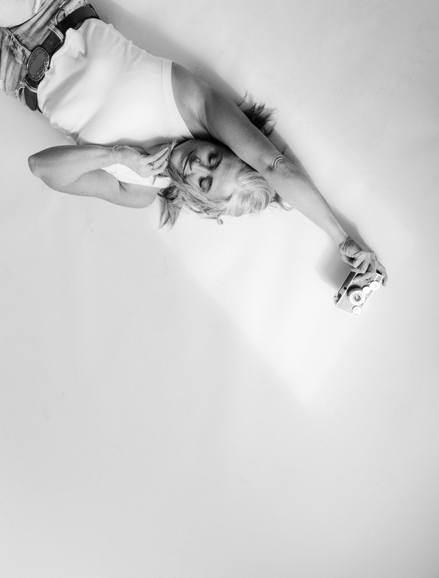Artistic black and white overhead portrait with dramatic shadows and lighting.