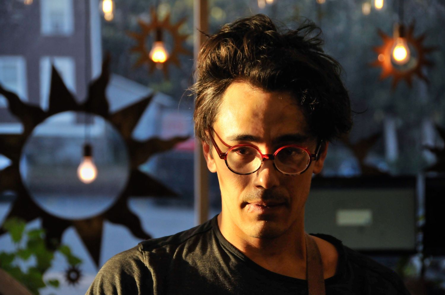 Man poses in golden hour light during portrait photography session.