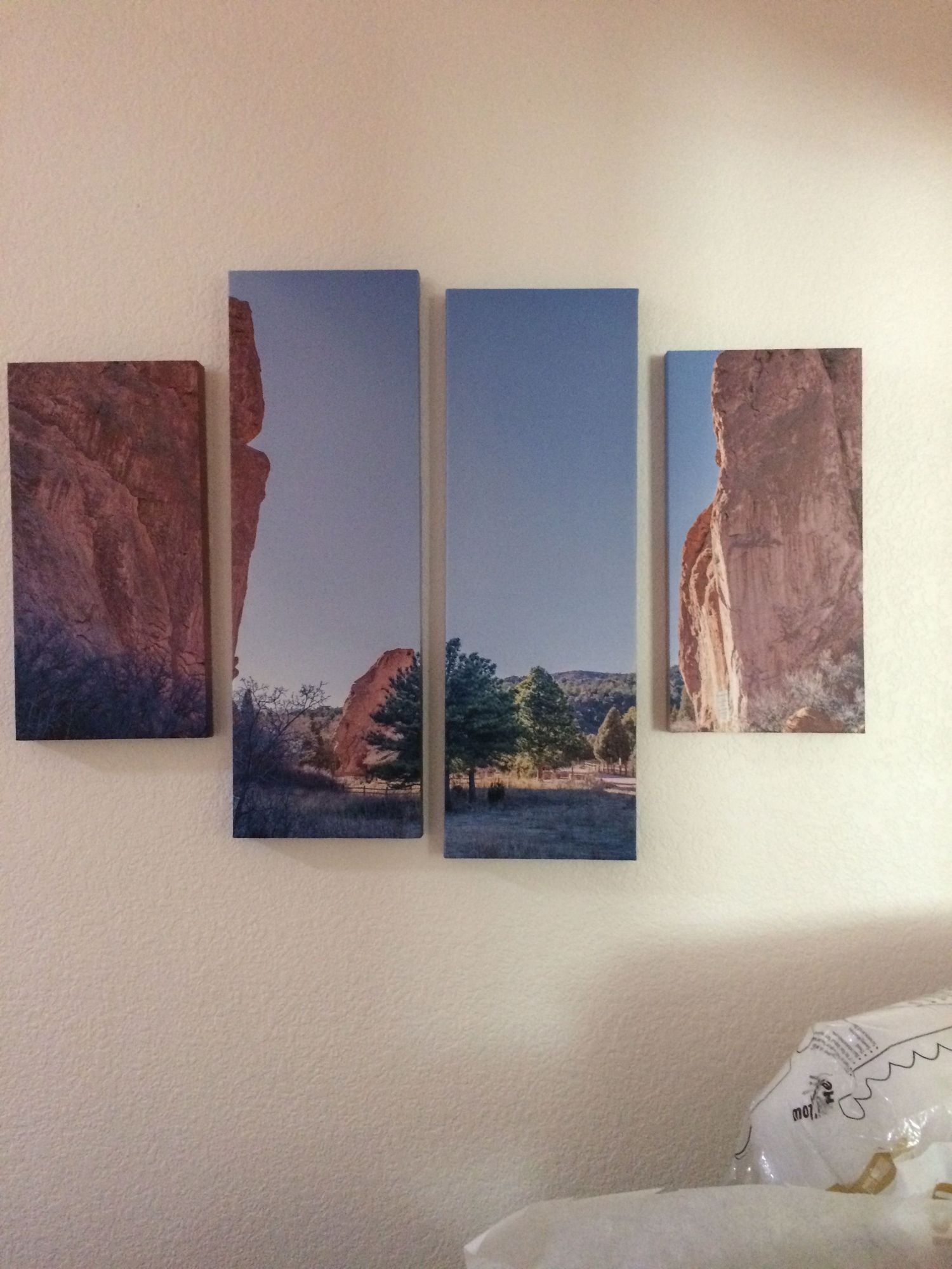 Several landscape photographs of desert rock formations and mountains arranged in a gallery wall display.