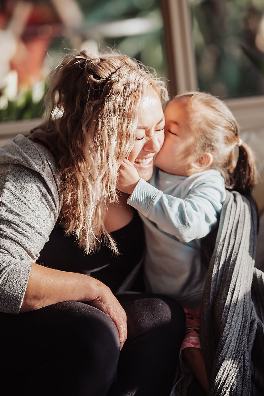 A series of intimate images showing tender moments between a parent and child sharing affectionate interactions.