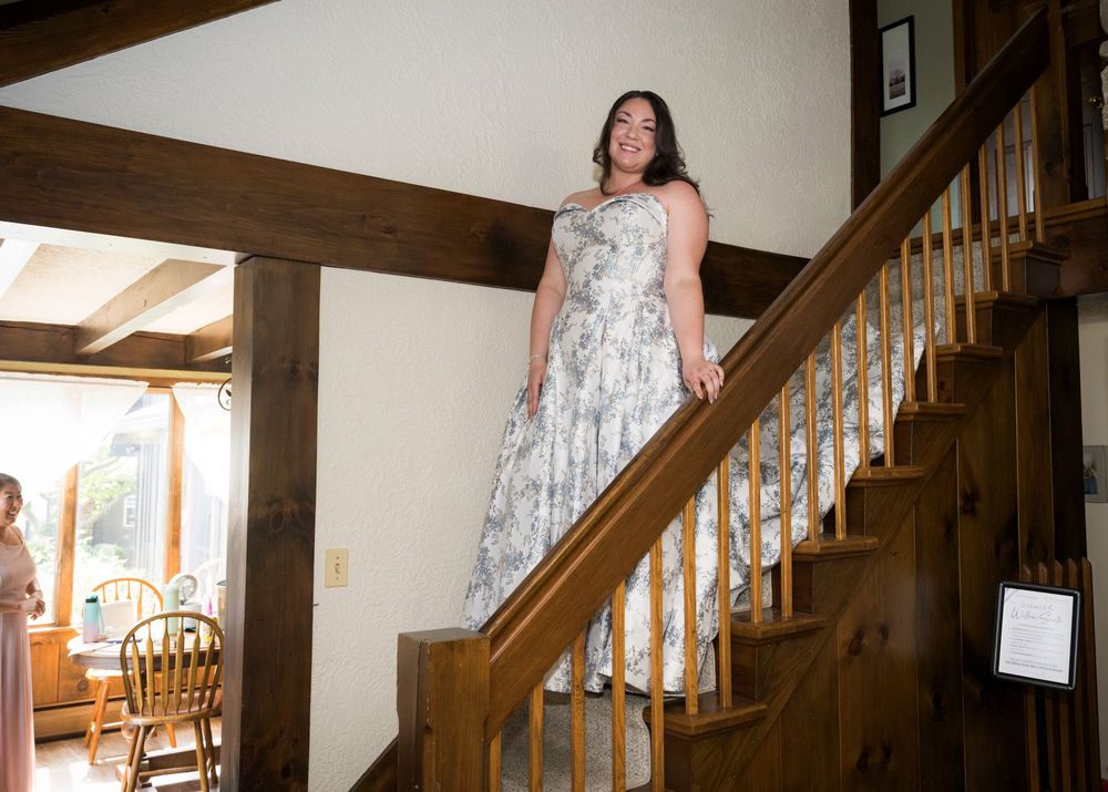 Interior shots showcase a rustic wooden staircase with elegant white railings and warm lighting in a residential home.