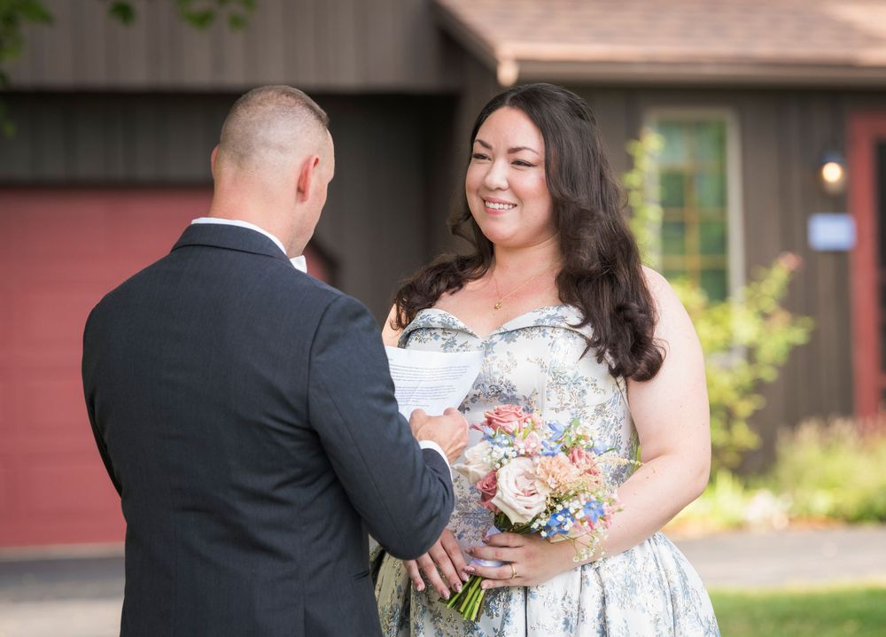 A couple sharing a tender moment during an outdoor wedding ceremony.