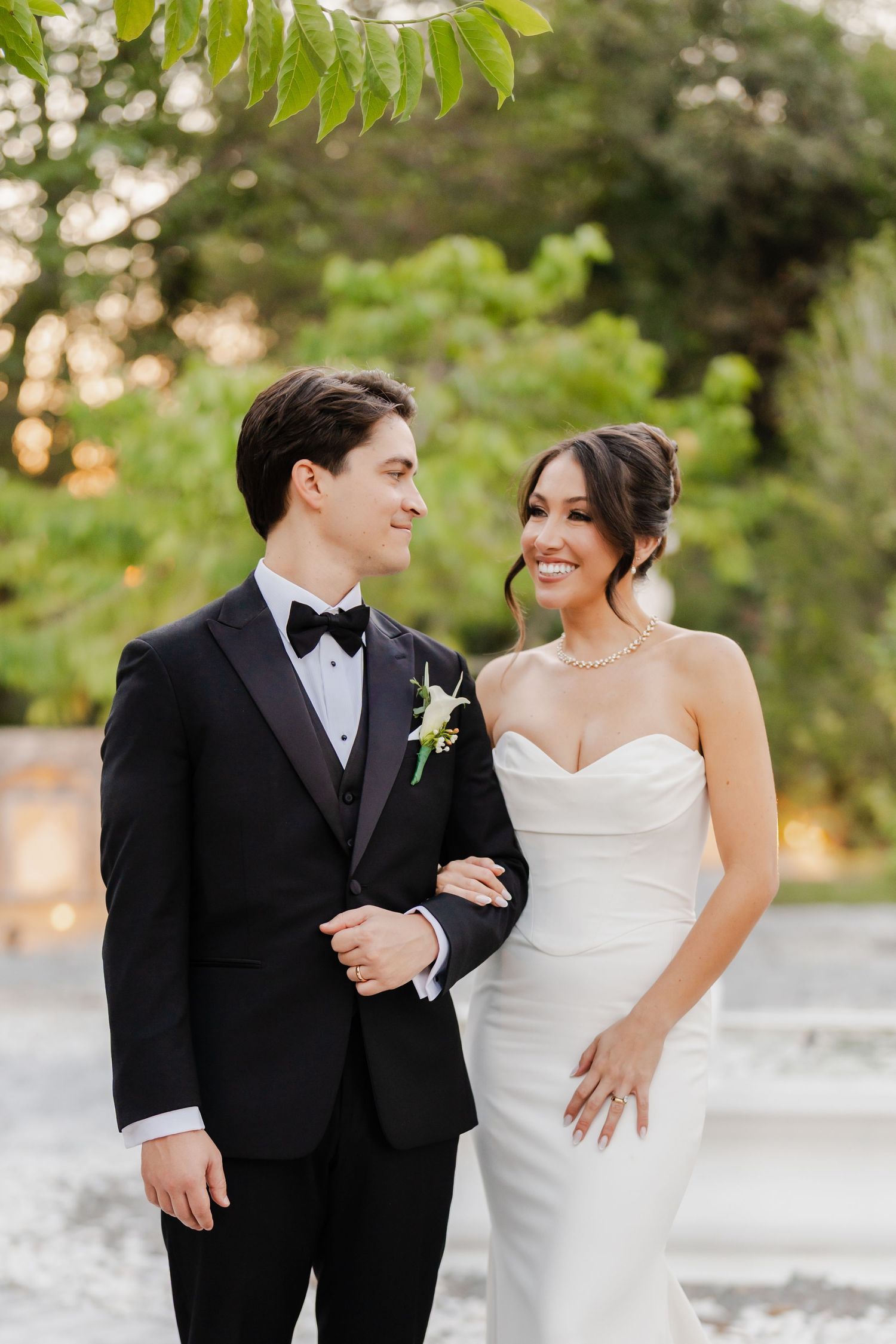 Groom's arms wrapped around bride at an oceanfront Florida wedding