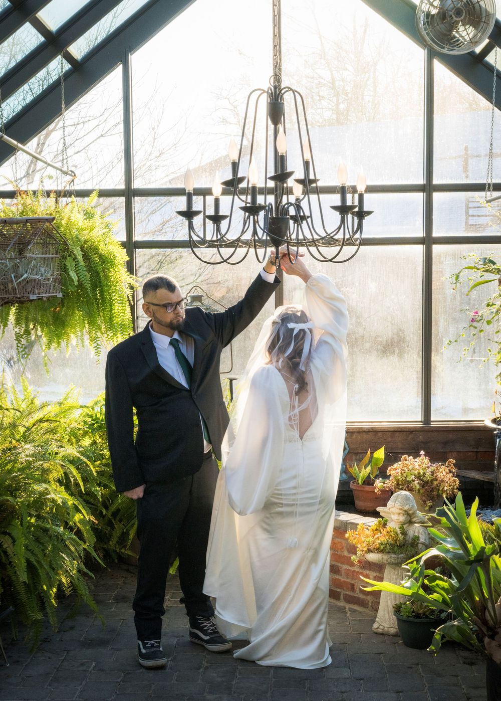 A series of wedding photos showing a couple in a greenhouse with hanging plants and chandeliers.
