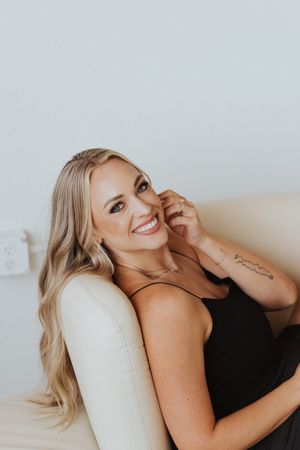 Relaxed lifestyle portrait session on beige couch with natural lighting.