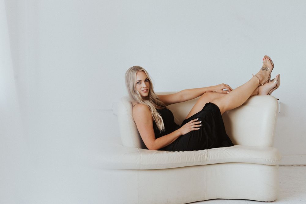 Artistic lounging poses captured during minimalist studio photoshoot.