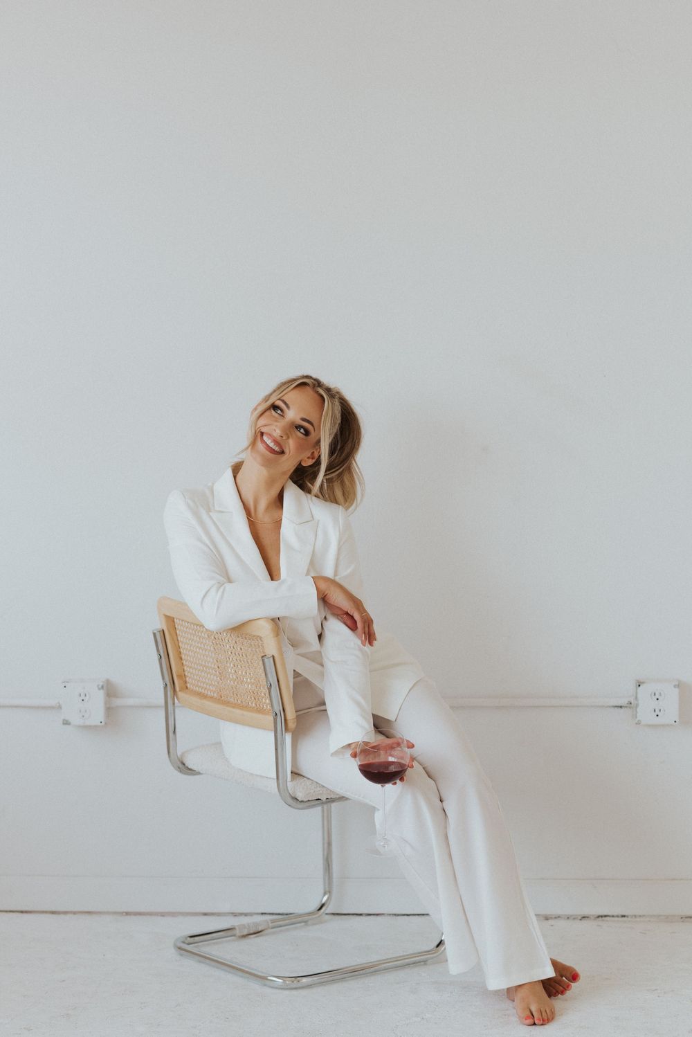 Casual lifestyle photoshoot on designer chair with relaxed poses.