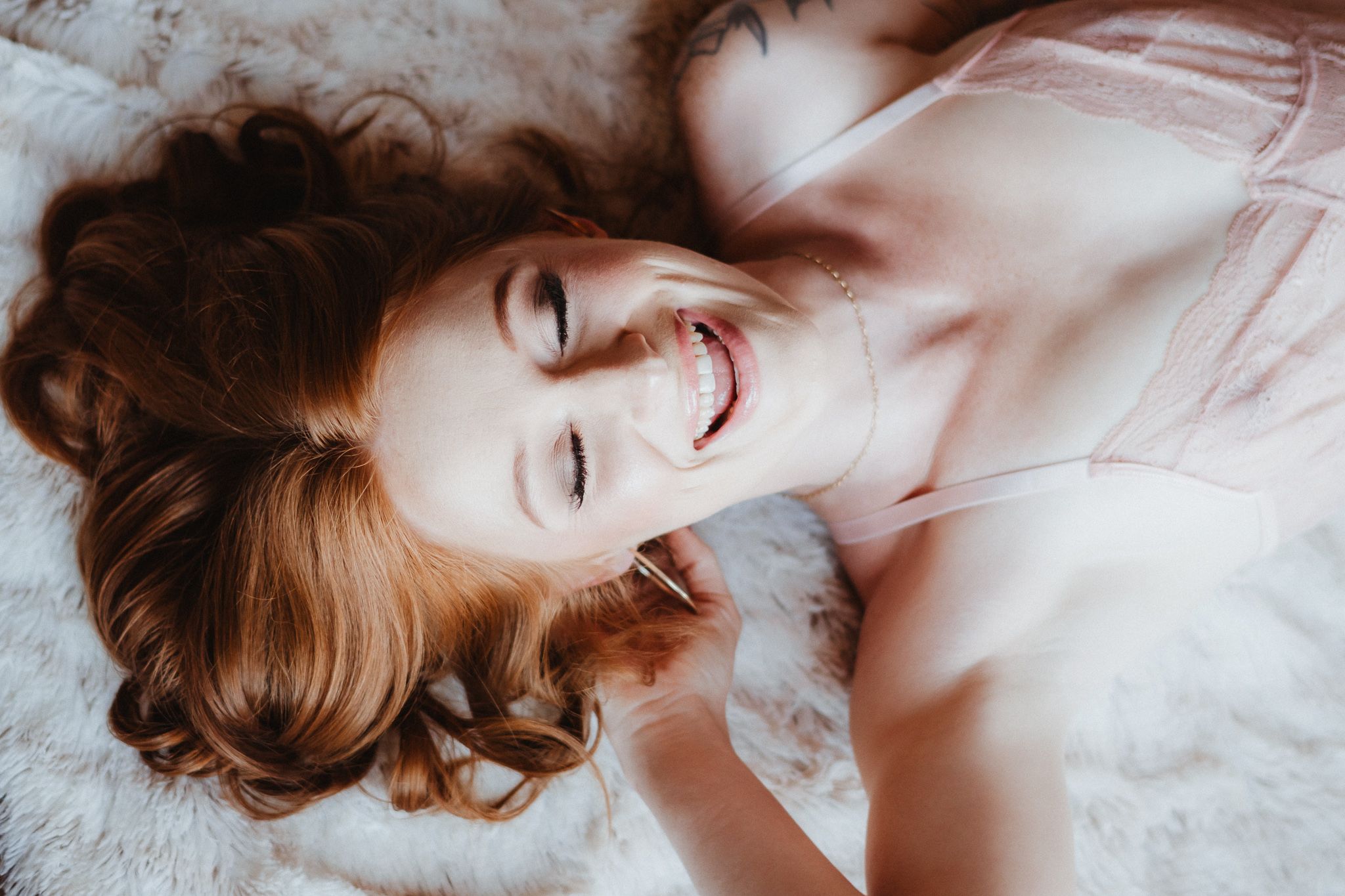 Intimate portrait series with delicate lighting and white background.