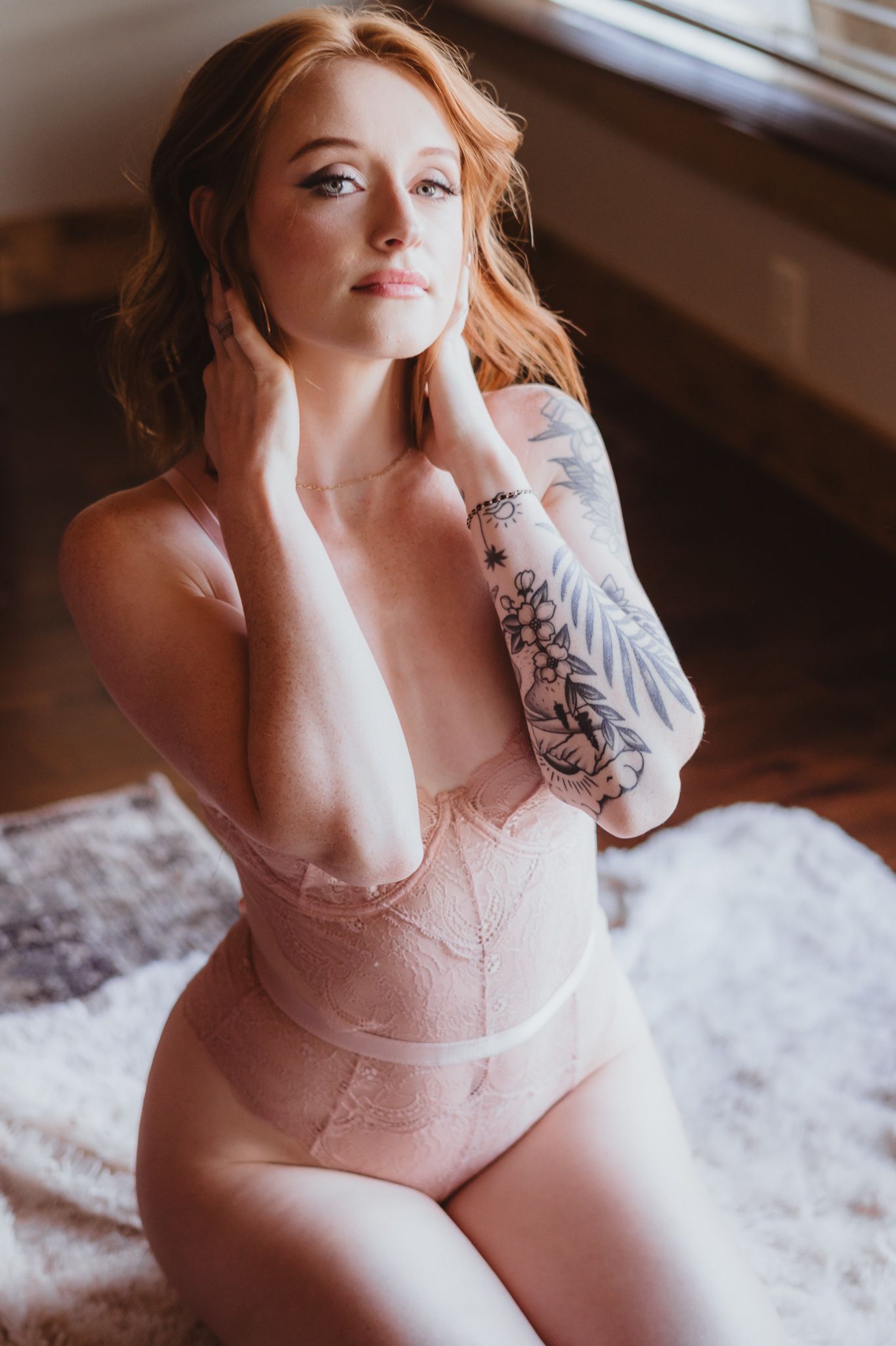 Intimate portrait session featuring pink lace and tattoo details.