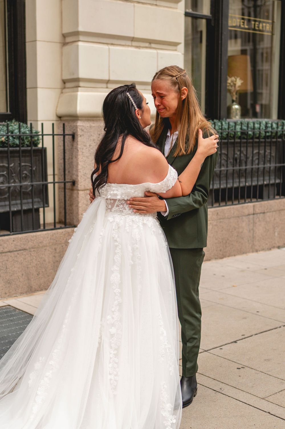 Four connected images show a touching first look moment between a couple on their wedding day outside a building.