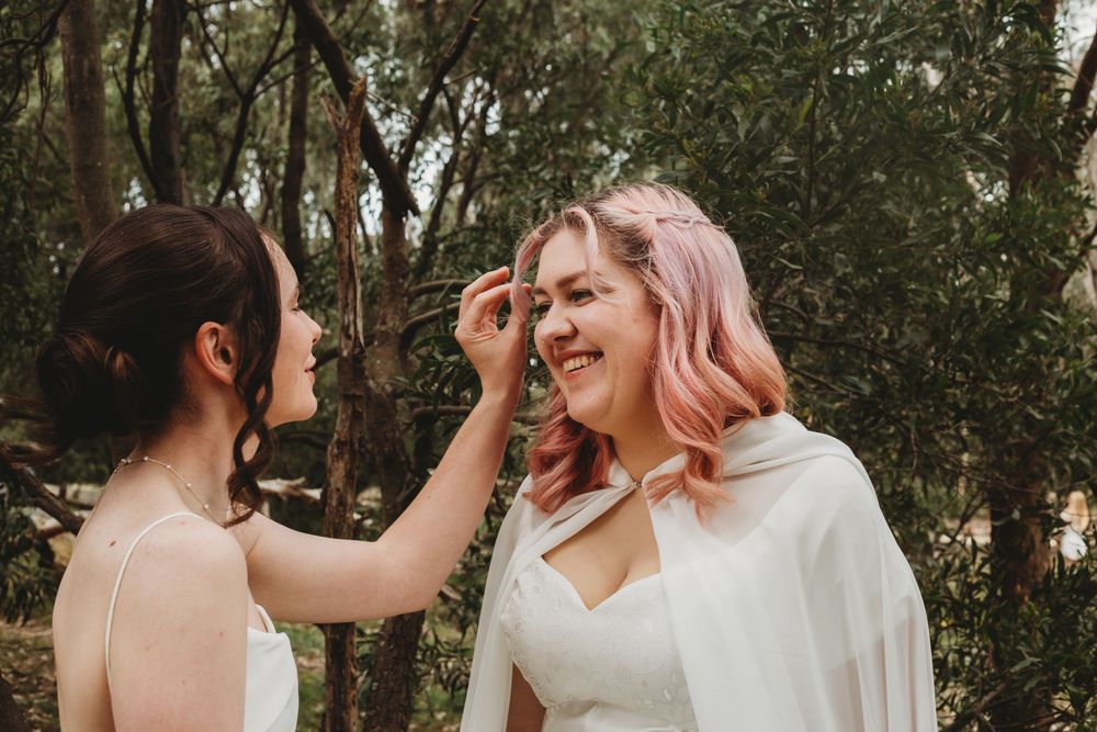 Wedding couple holds hands and shares intimate moments in a lush garden setting during their special day.