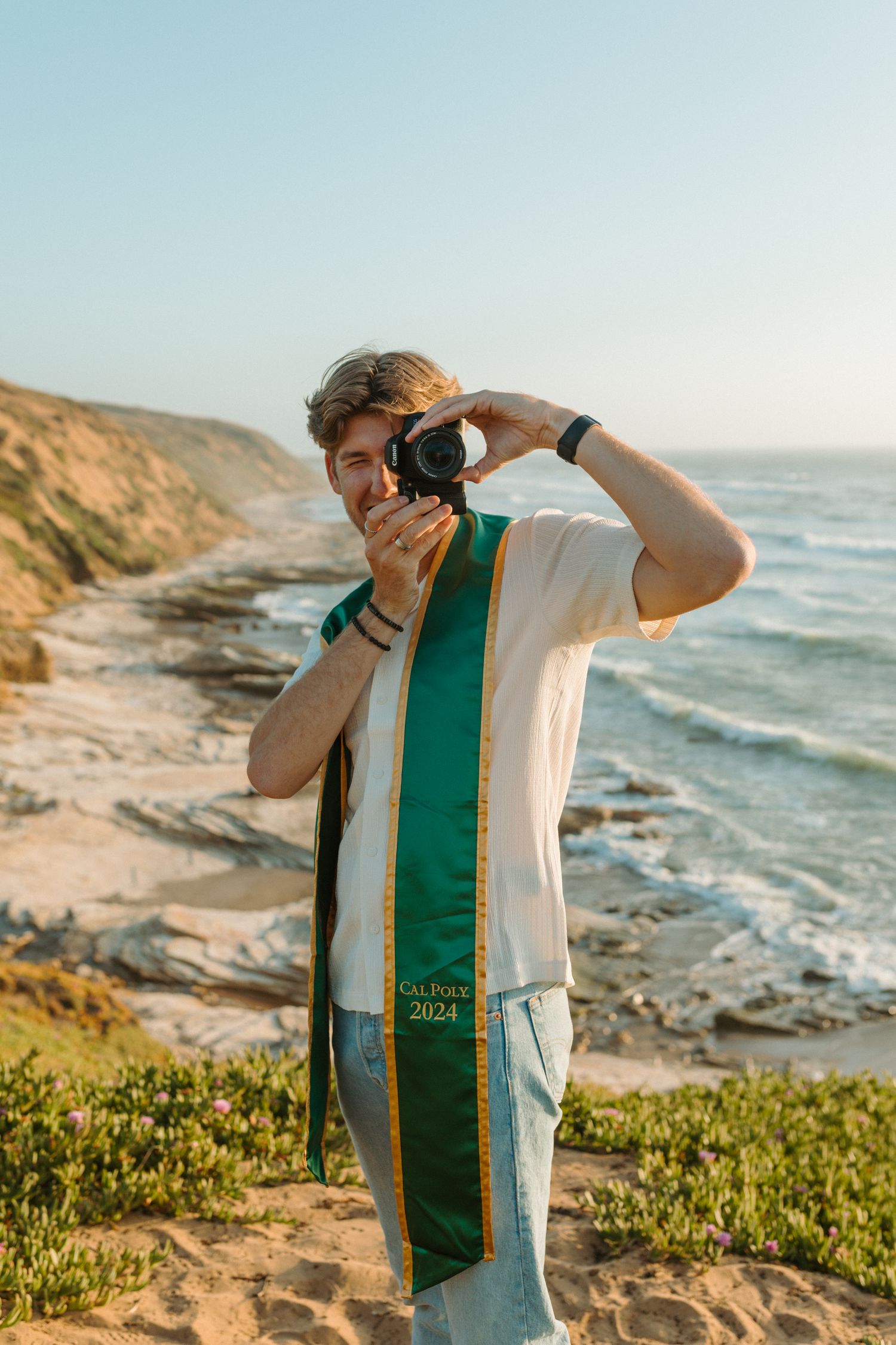 Photographer capturing coastal scenery at scenic California beach overlook.