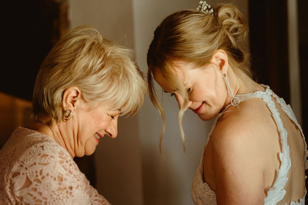 An intimate moment captured between family members sharing a tender smile in warm lighting.