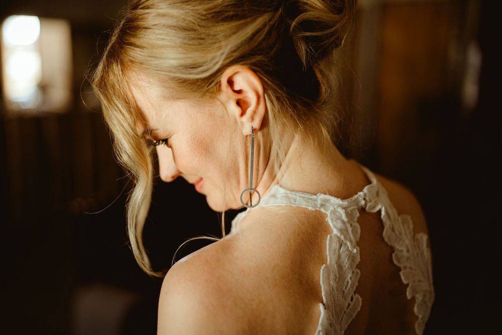 A close-up profile shot showcasing delicate lace details of a wedding dress.