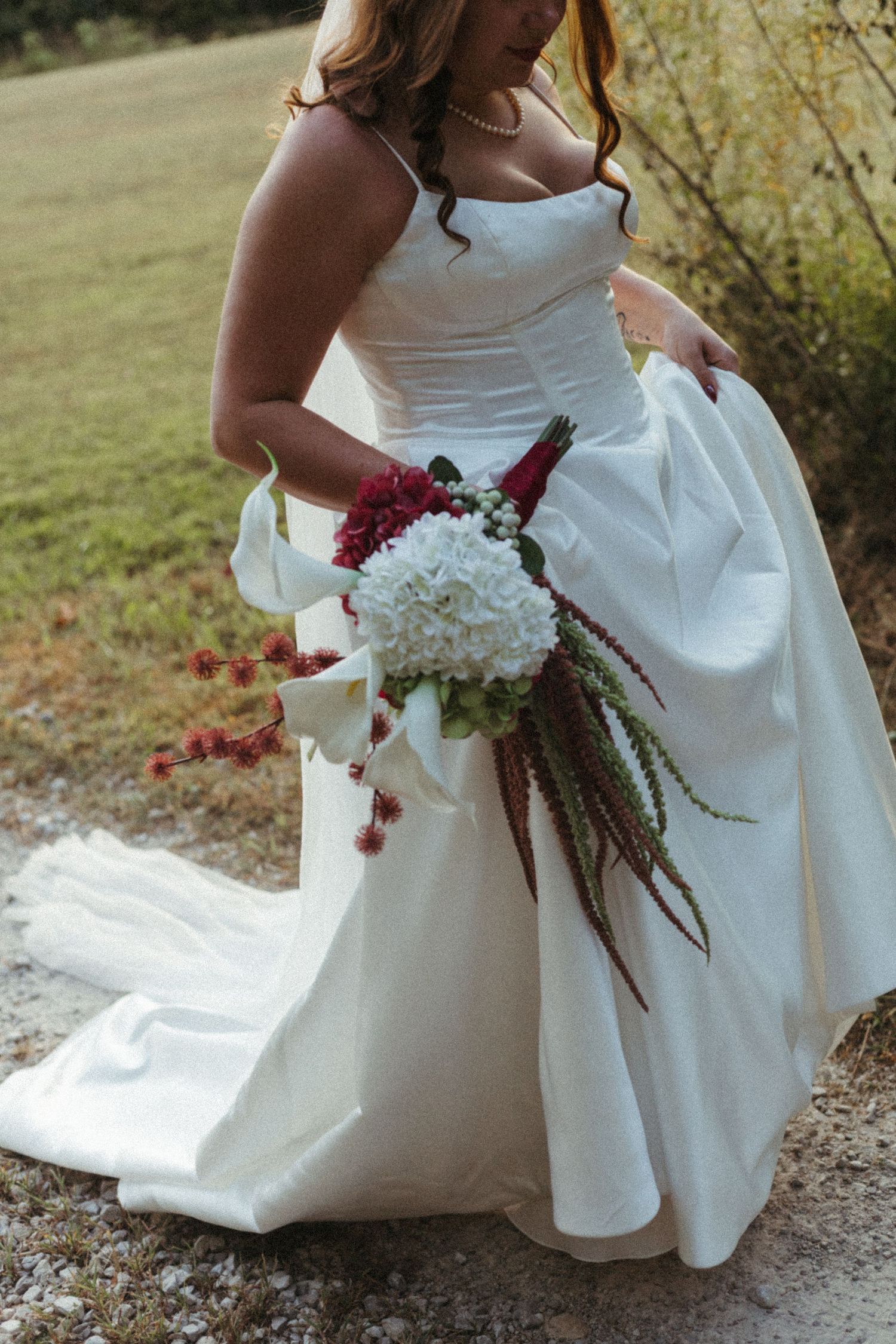 Wedding guests dance with sparklers creating light trails during a nighttime celebration.