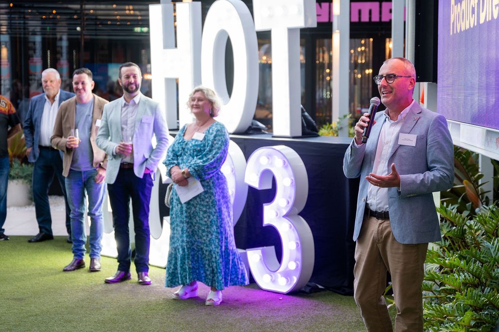Event attendees gathering near large illuminated numbers and decorative displays at an evening celebration.