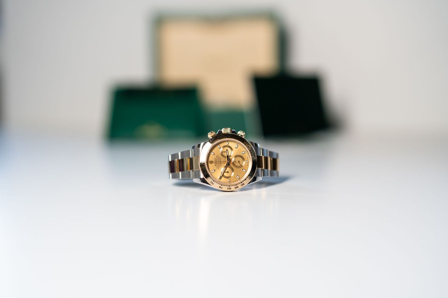 A vintage gold ring with intricate floral engravings and a small center stone displayed on a white surface.