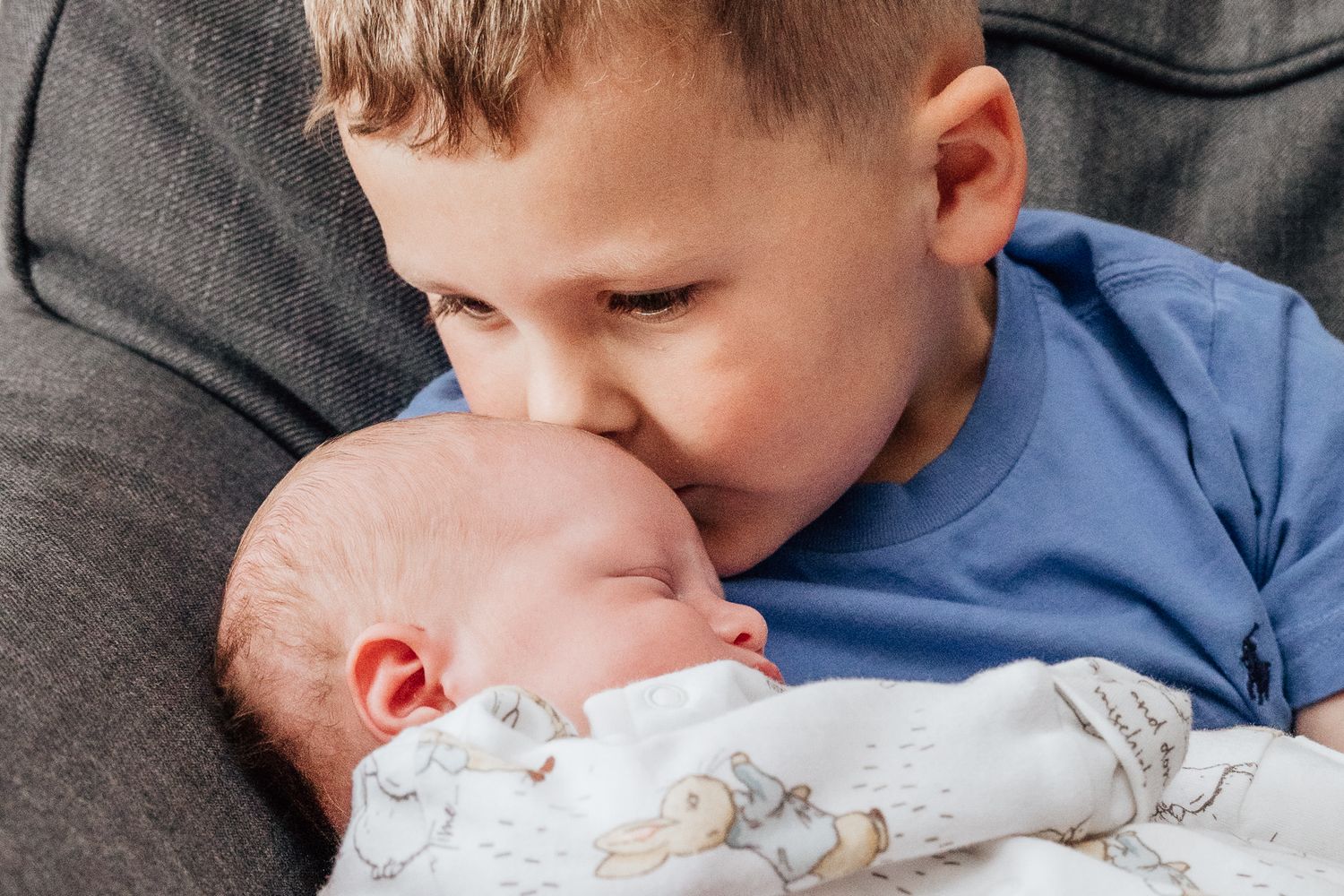brother kissing baby