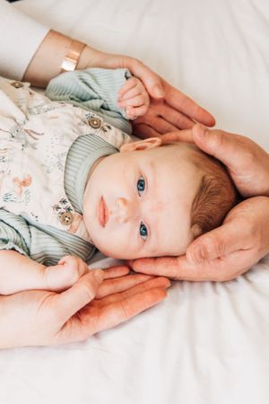 baby with parents' hands