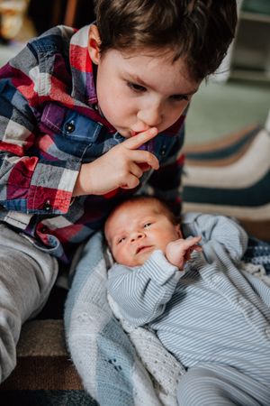 brother hushing baby