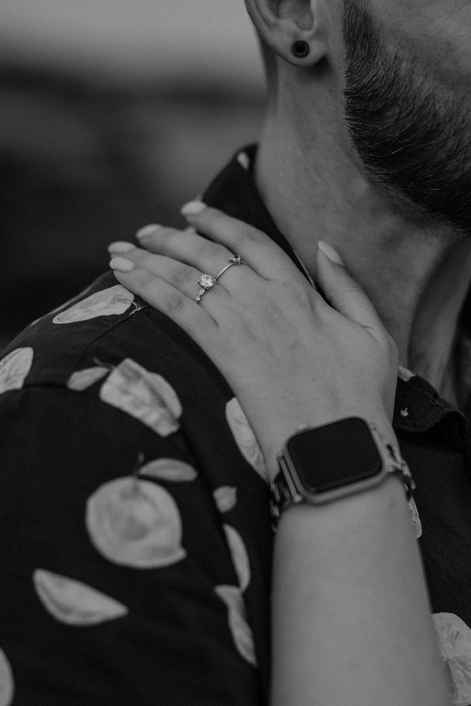 Close-up black and white shot of hands tenderly touching.